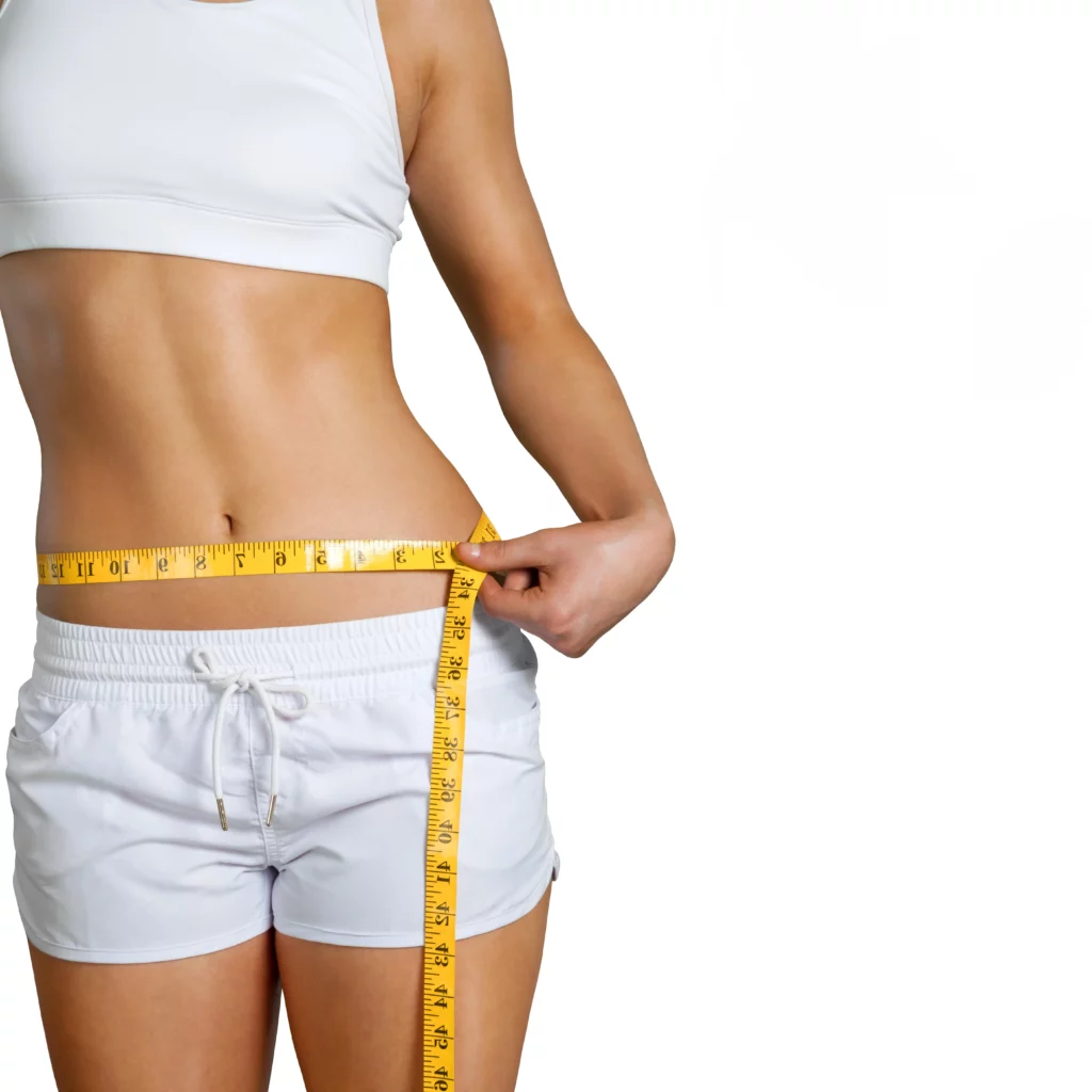 a woman measuring her waist